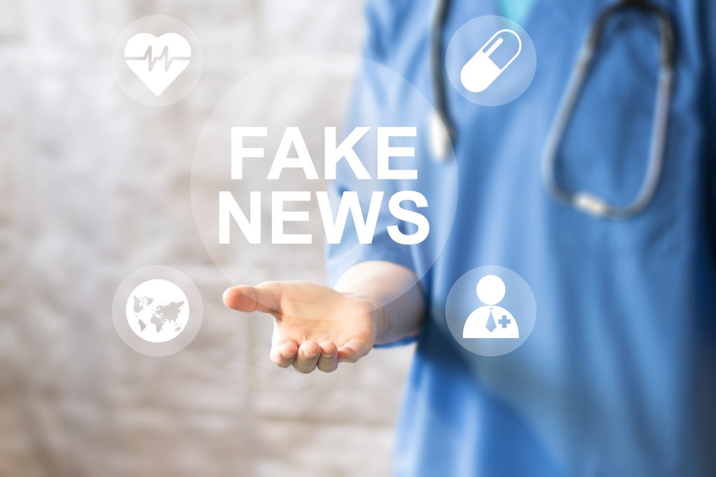 Doctor pressing button Fake News healthcare on virtual panel medicine