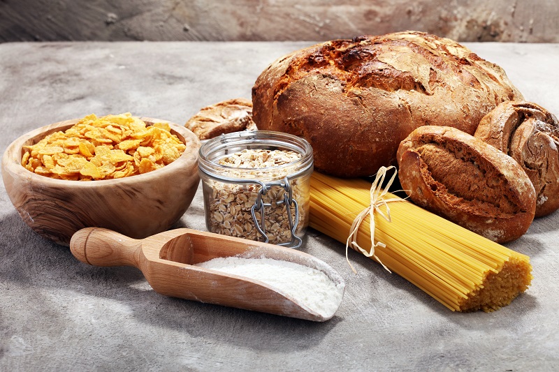 whole grain products with complex carbohydrates on rustic background