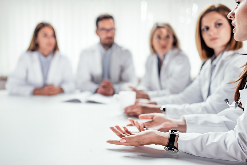 Cropped image of medical doctors discussing during the conference. Copy space.