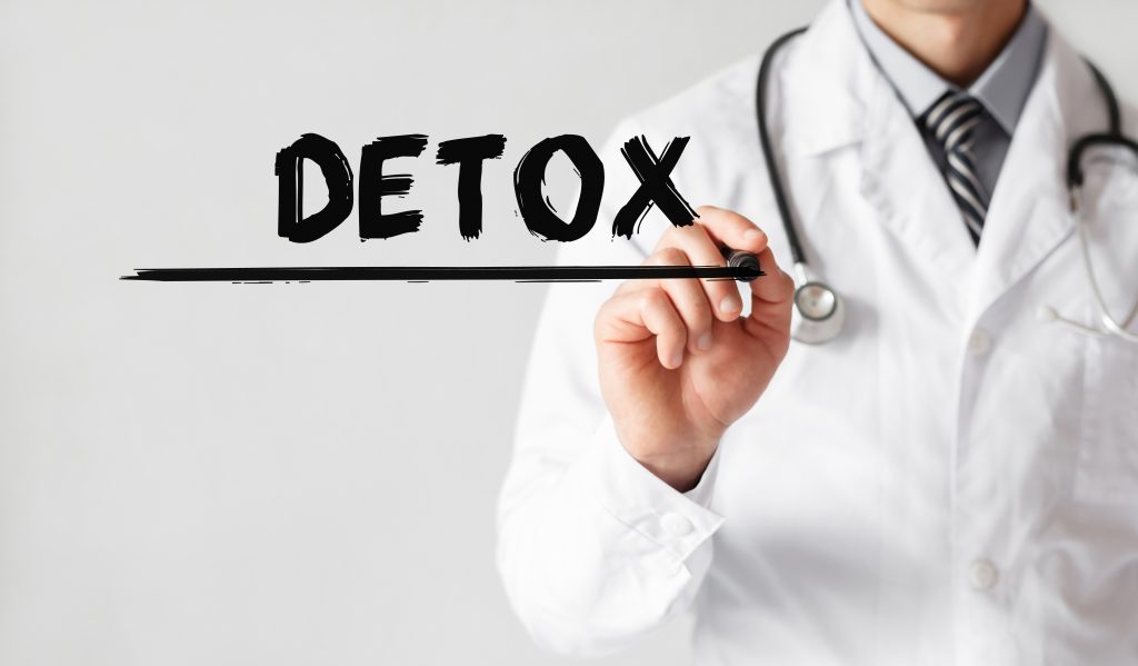 Doctor writing word Detox with marker, Medical concept